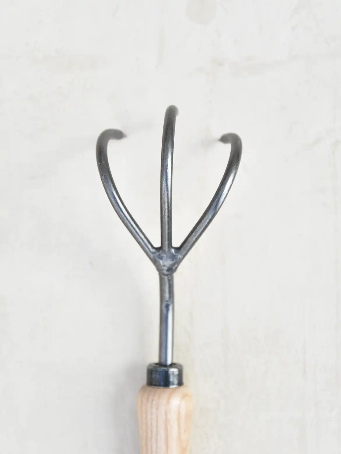 Curved tines of steel cultivator for soil aeration - product image.